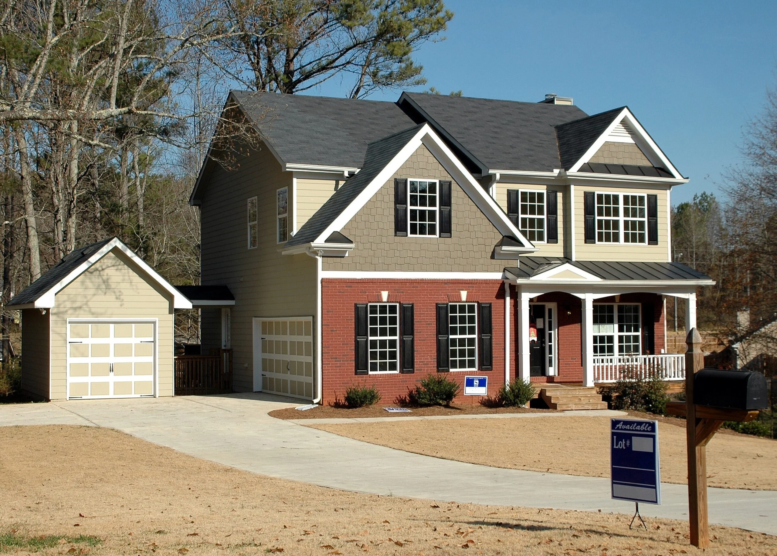 two story home with garage and yard sign