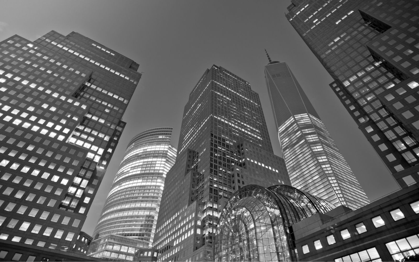 Modern office skyscrapers illuminated at night in downtown.