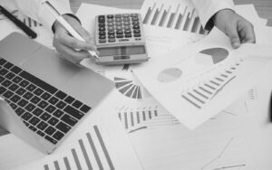 Professionals reviewing apartment rental data and real estate reports on digital devices.