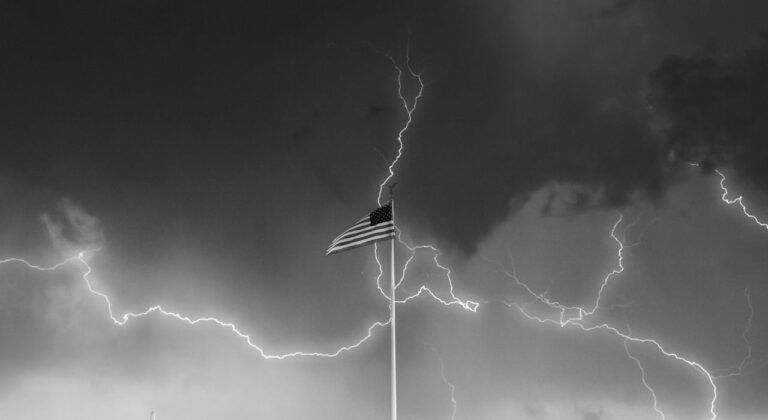 American flag against a stormy sky with lightning, symbolizing controversy surrounding Trump’s $250 million White House ballroom project.