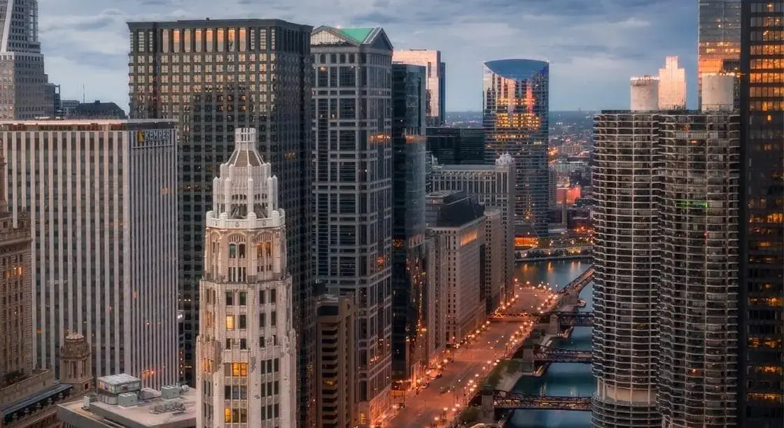A view of downtown Chicago at dusk, representing the region at the center of Zillow’s dispute with MRED over private listing network rules.